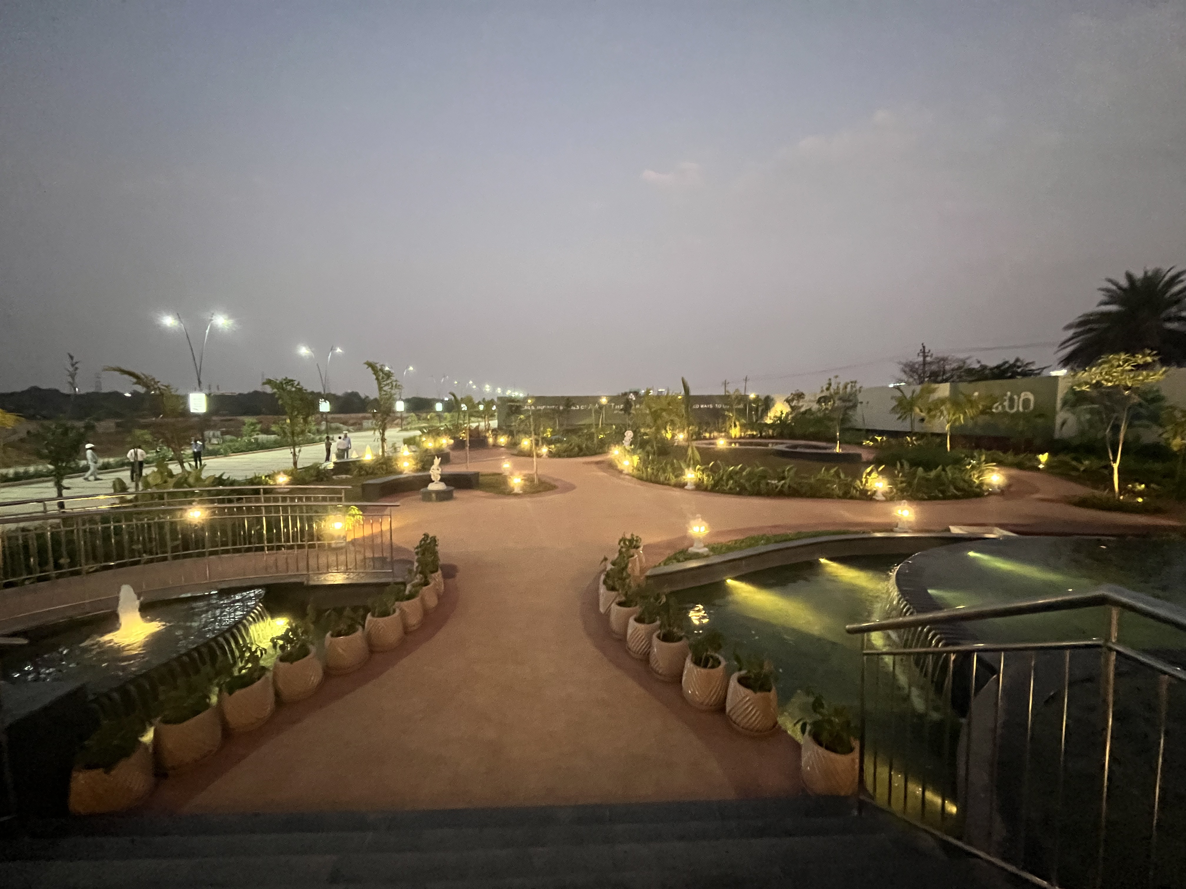 Century OneWorld Seraya amenities with evening water features and fountains